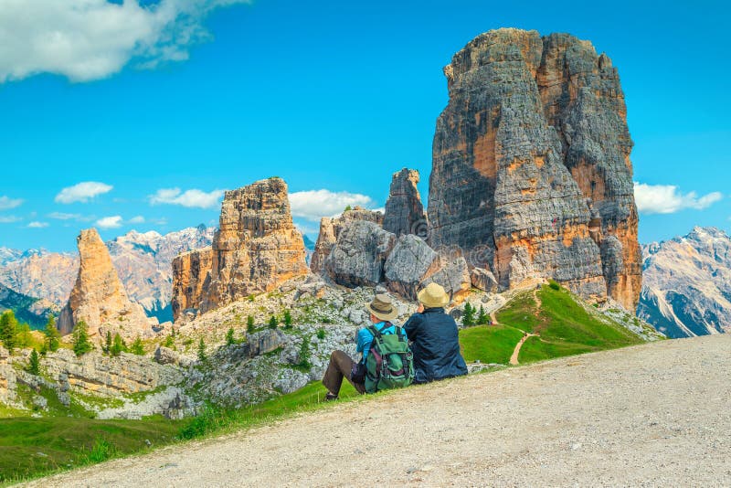 Cheerful mature couple sitting in mountains and enjoying the view. Happy elderly couple sitting in the mountains. Hiker senior couple with backpack relaxing near stock images Cheerful mature couple sitting in mountains and enjoying the view. Happy elderly couple sitting in the mountains. Hiker senior couple with backpack relaxing near stock images