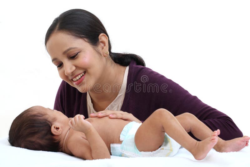 Cheerful mother playing with newborn royalty free stock images Cheerful mother playing with newborn royalty free stock images