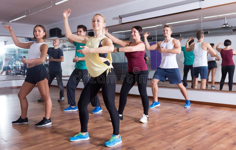 Cheerful ordinary adults dancing bachata