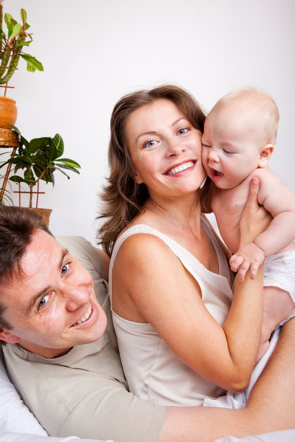 Cheerful parents and a baby stock photo Cheerful parents and a baby stock photo