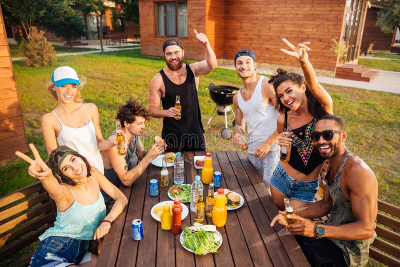 Cheerful People Having Fun And Eating At The Table Outdoors Stock Image
