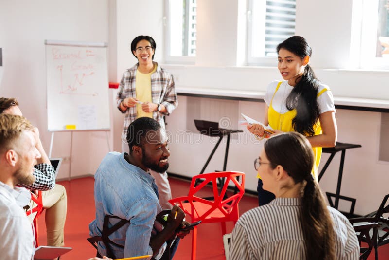 Cheerful people smiling and having emotional discussion stock photo Cheerful people smiling and having emotional discussion stock photo