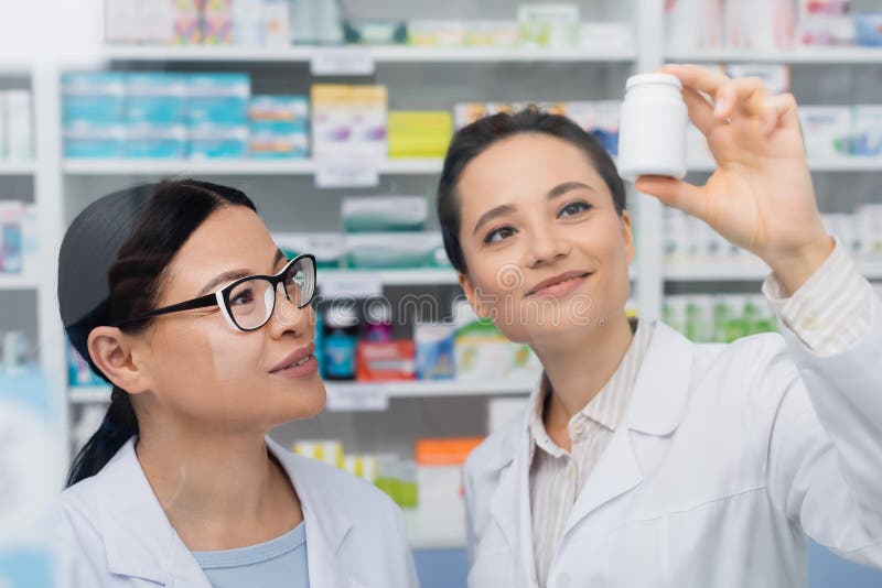 Cheerful Pharmacist in White Coat Holding Stock Photo - Image of adult ...