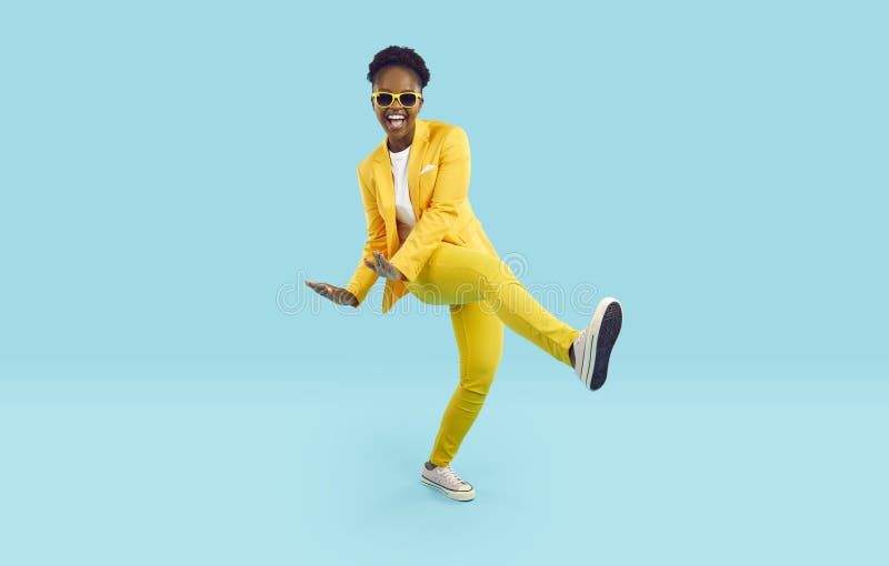 Cheerful, positive and energetic african american woman dancing with funny crazy expression. stock photography
