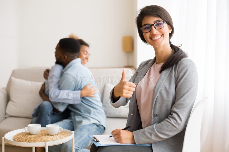 Cheerful Psychologist Gesturing Thumb Up while Happy Afro Couple Hugging  Stock Image - Image of effective, husband: 154092837