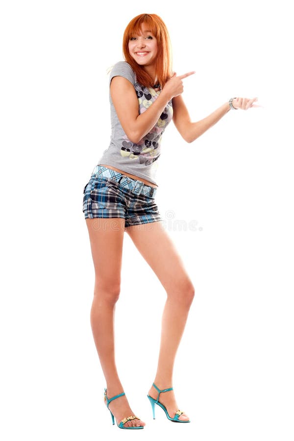 Cheerful red-haired girl in a t-shirt and shorts