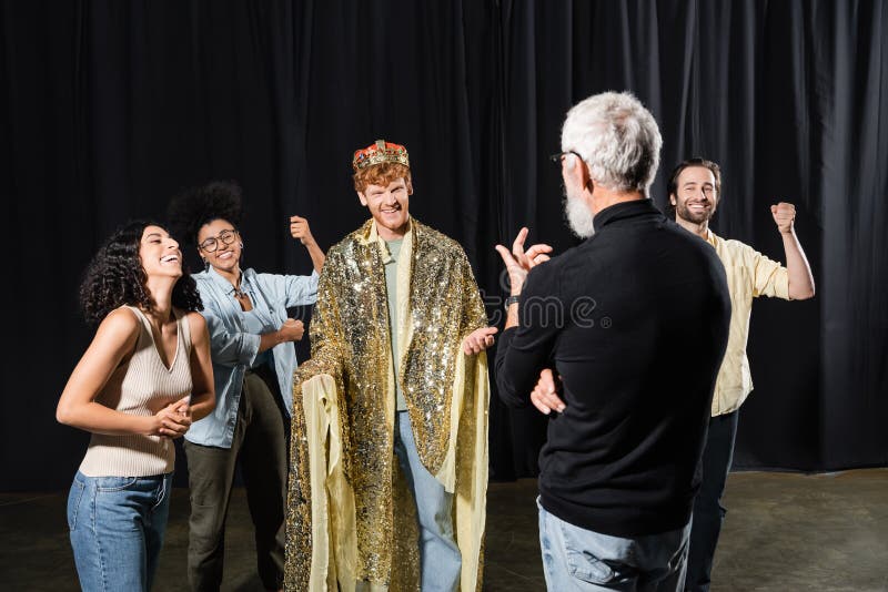 Cheerful redhead man in king costume stock photos