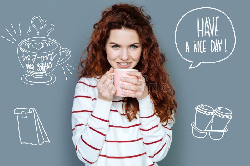 Cheerful secretary looking relaxed while drinking hot coffee