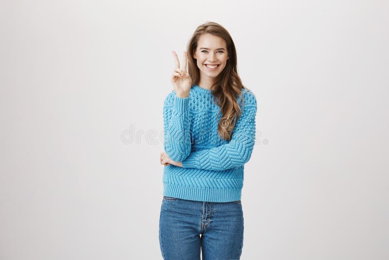 Cheerful and Sincere Girl Showing Victory or Peace Sign while Crossing ...