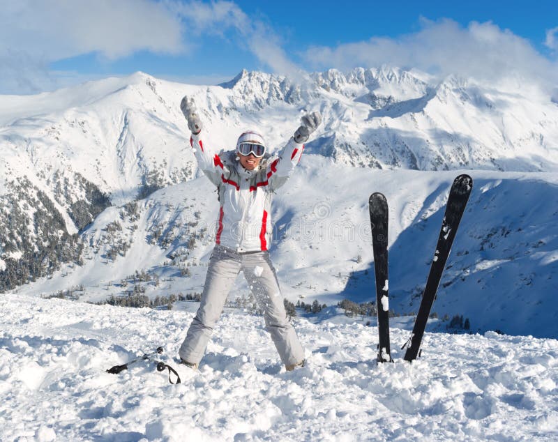 Cheerful skier on the top of mountain Pirin