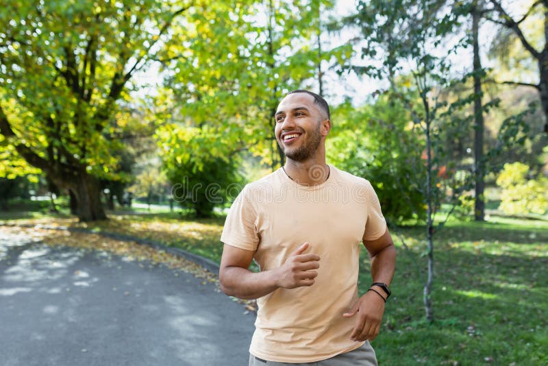 Cheerful And Successful Hispanic Man Jogging In The Park Man Running