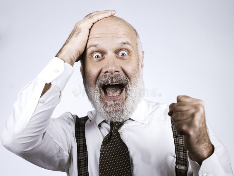 Cheerful successful senior businessman celebrating stock photo Cheerful successful senior businessman celebrating stock photo