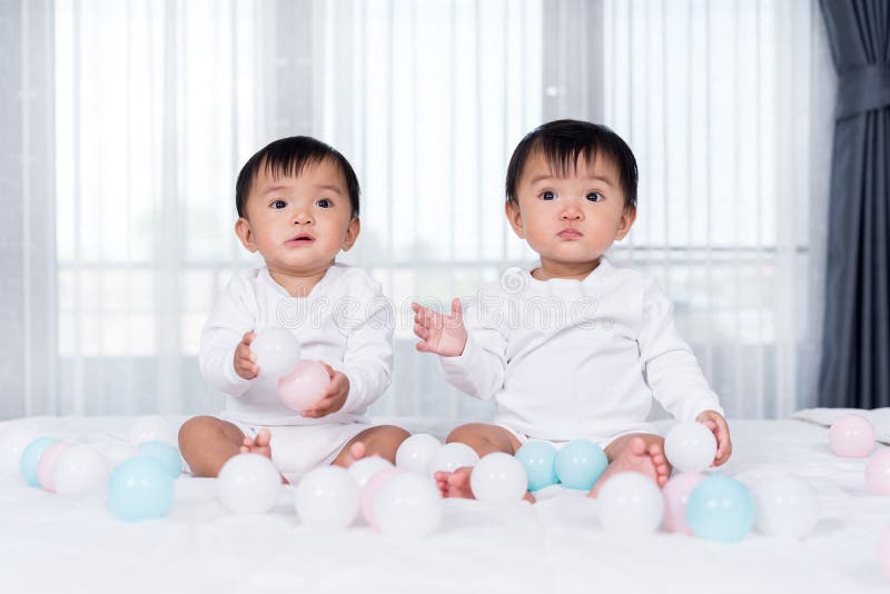 Cheerful Twin Babies Playing Color Ball on Bed Stock Photo Image of