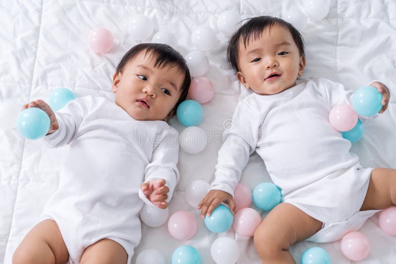 Cheerful Twin Babies Playing Color Ball on Bed Stock Image Image of