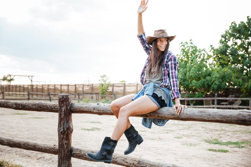 Cheerful Woman Cowgirl Sitting on Fence and Having Fun Stock Image ...