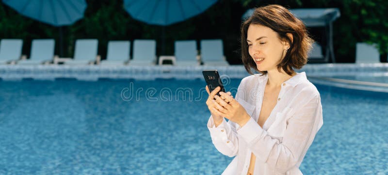 Veselý žena s zbytek nejblíže plavání bazén mobilní telefon vývody žít přenos nebo má volání přátelé.