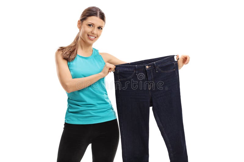 Cheerful Woman Holding a Pair of Oversized Jeans Stock Photo - Image of ...