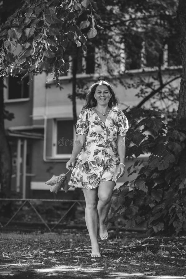 Cheerful Woman In A Short Dress With Bare Nagas In Nature Black White Photo Stock Image