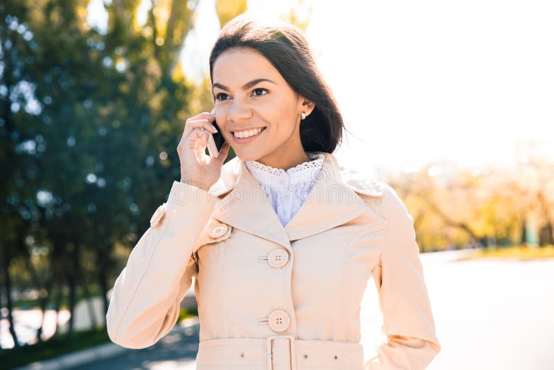 Cheerful woman talking on the phone royalty free stock photography