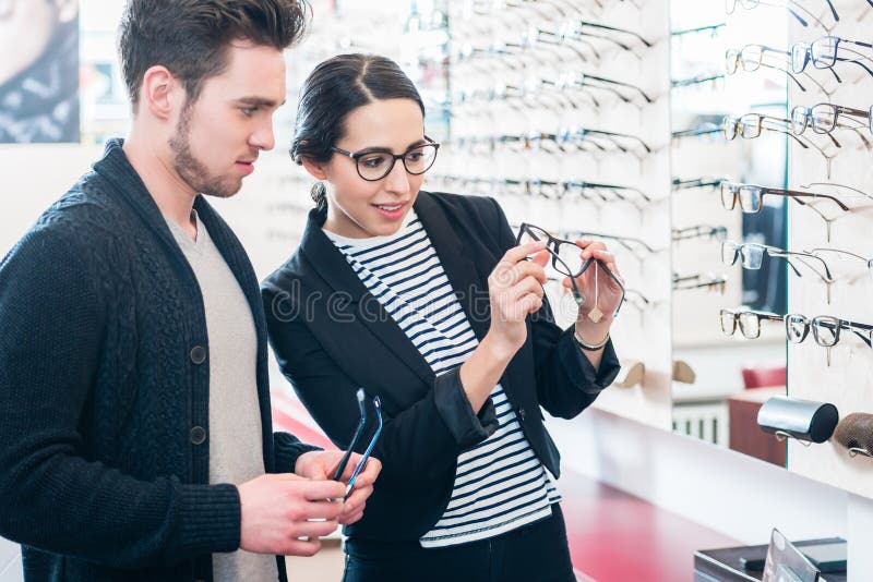 Woman And Man Buying Glasses In Optician Shop Stock Image - Image of ...