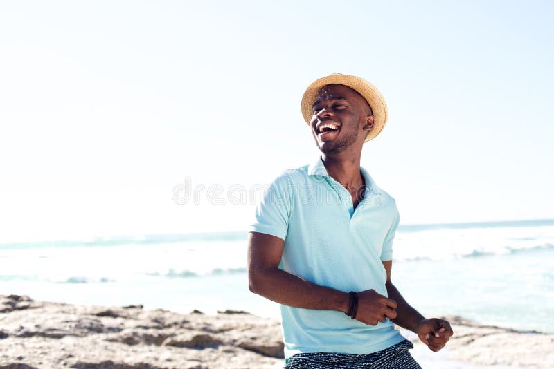 Cheerful young african man enjoying at the beach stock image Cheerful young african man enjoying at the beach stock image