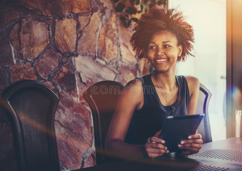 Black smiling girl with digital pad in meeting room stock images Black smiling girl with digital pad in meeting room stock images