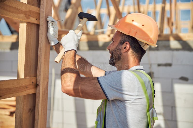 Cheerful Young Builder Working at Housing Development Stock Image