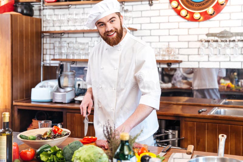 Cheerful Young Chef Cook Cutting Meat and Making Vegetable Salad Stock ...