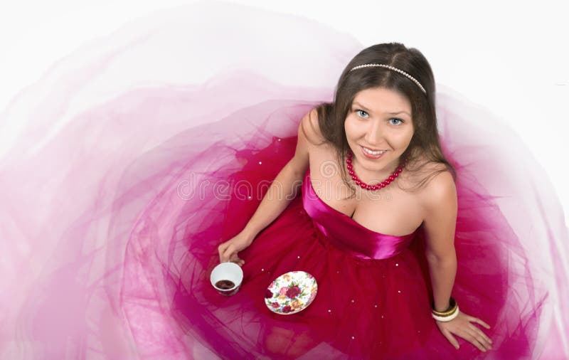 Cheerful young female smiling and holding a cup of coffee stock image Cheerful young female smiling and holding a cup of coffee stock image
