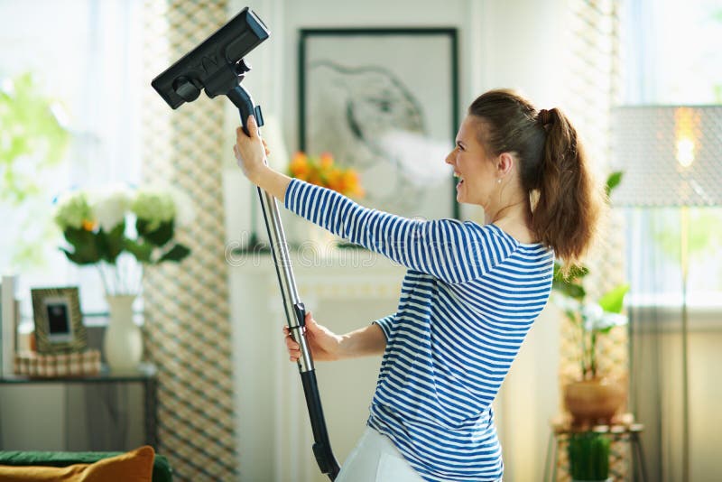 Cheerful Young Female with Vacuum Cleaner Doing Housework Stock Photo ...
