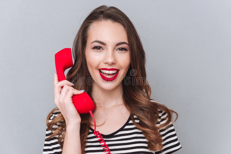 Cheerful Young Lady Standing Over Grey Wall Talking by Phone Stock Photo Image of person