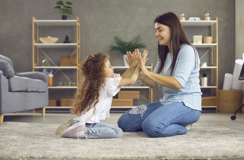 Family, video game and online gaming on home sofa with a pregnant mother  and daughter on a living room couch together while happy and having fun.  Woman and girl kid together for