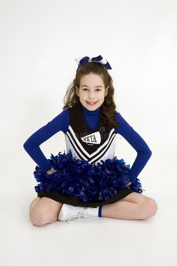 Nine Year Old Caucasian Girl Dressed in a Blue Cheerleader Outfit Stock