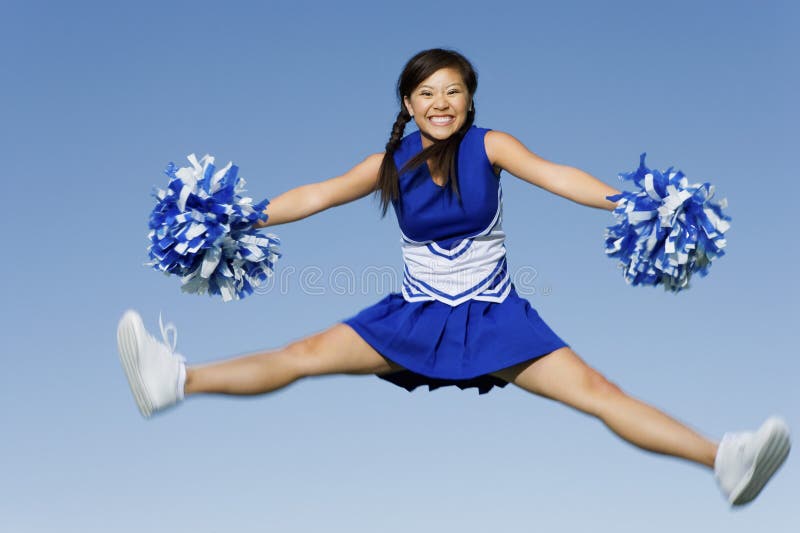 Cheerleader Jumping with PomPoms Stock Photo Image of adult