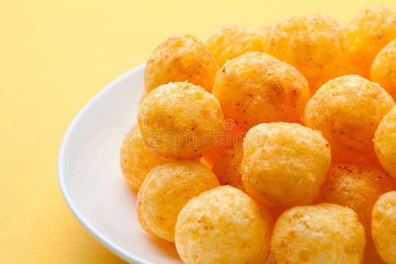 Delicious crispy Cheese ball in paper bucket isolated on white background, Cheese  ball or cheesy puffs on white With clipping path. Stock Photo