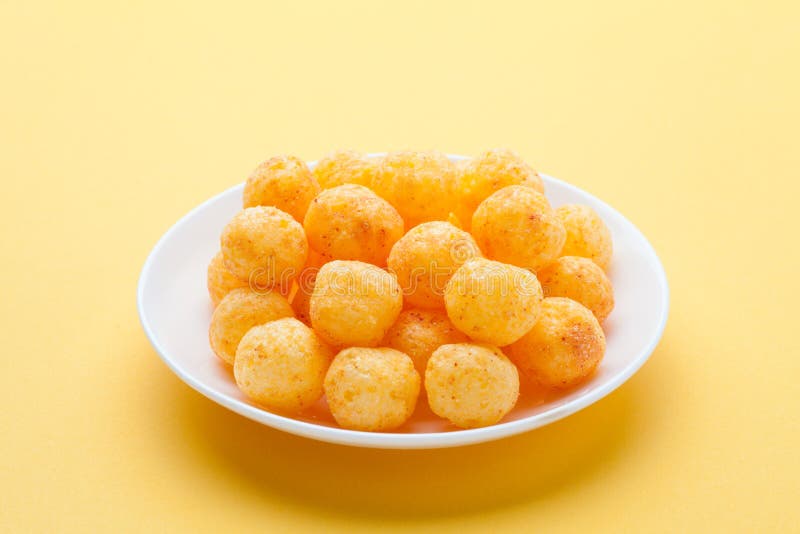 Cheese Balls on Yellow Background Stock Photo - Image of closeup, group: 139133182