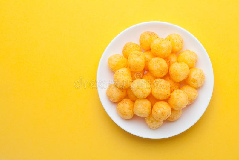 Cheese Balls on Yellow Background Stock Photo - Image of closeup, group: 139133182