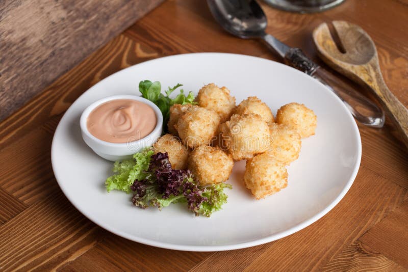 Cheese balls breaded with herbs in still life stock image Cheese balls breaded with herbs in still life stock image