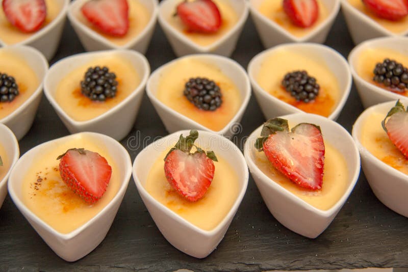 Cheese cake in white cup ontop fruit