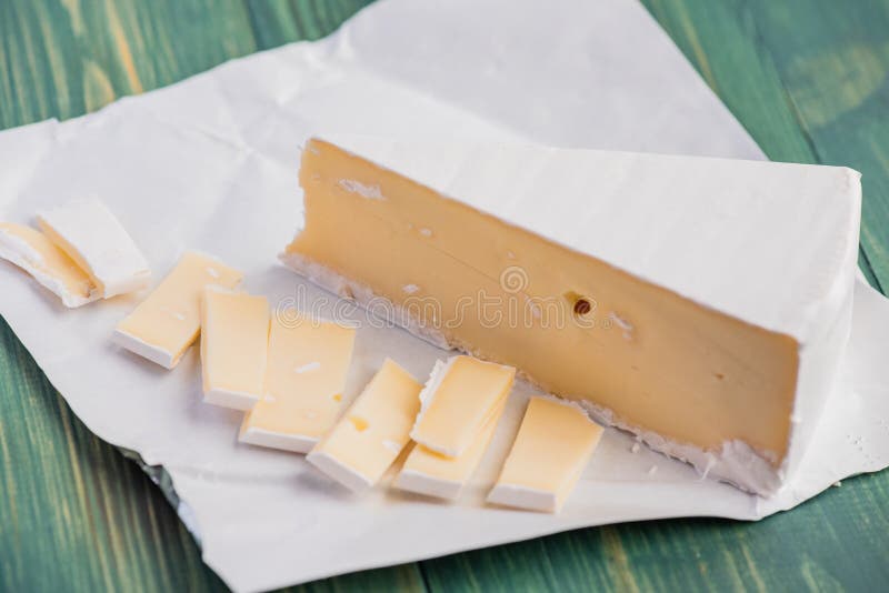 Cheese Camembert. Delicious Pieces of White Mold Cheeses with Soft