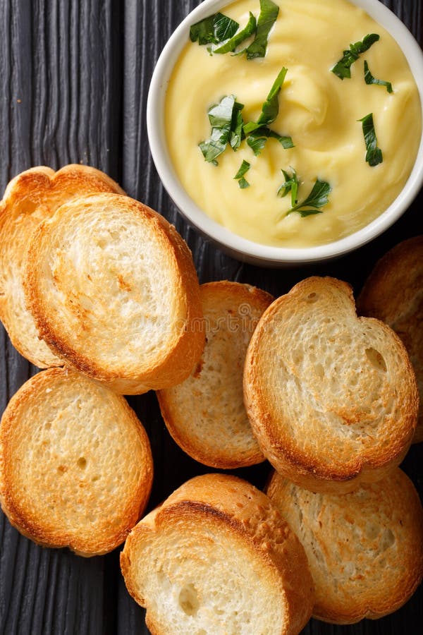 Cheese Dip Sauce with Toasted Bread Closeup. Vertical Top View Stock