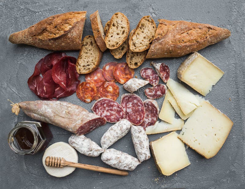 Cheese and meat appetizer selection or wine snack set. Variety of italian cheese, salami, bresaola, baguette, honey on