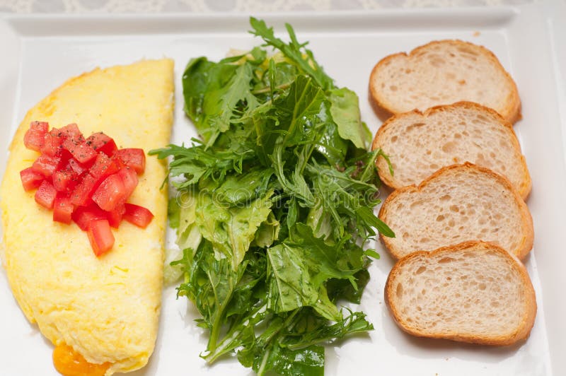 Cheese ometette with tomato and salad