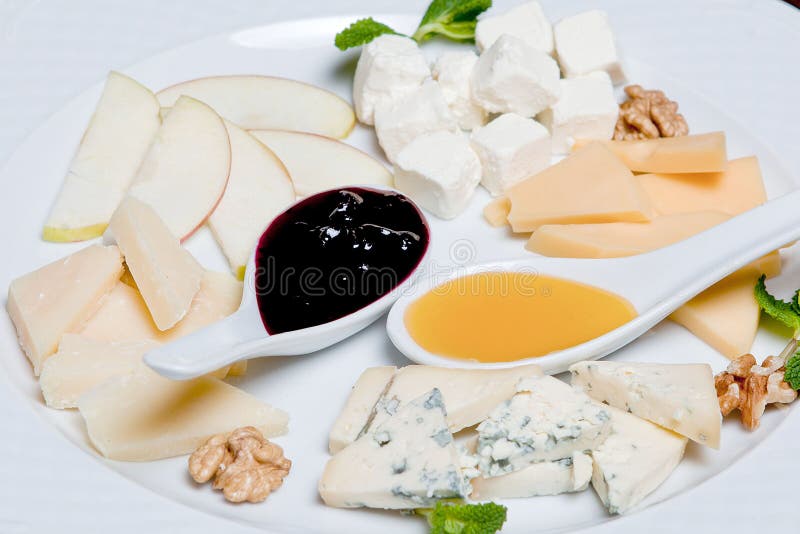 Cheese Plate on a Black Table. Many Kinds of Cheese Stock Photo Image