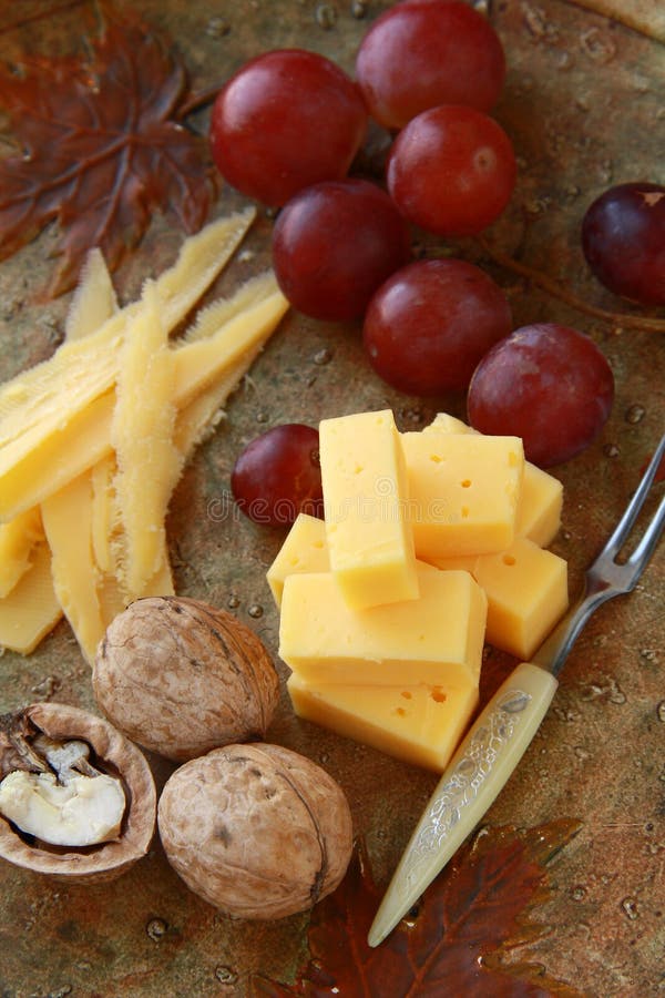 Cheese plate with grapes stock photo. Image of eating 19180294