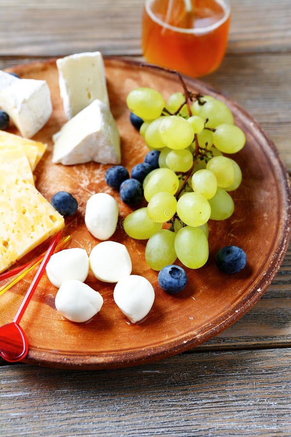 Cheese plate with grapes stock image. Image of honey 44461781