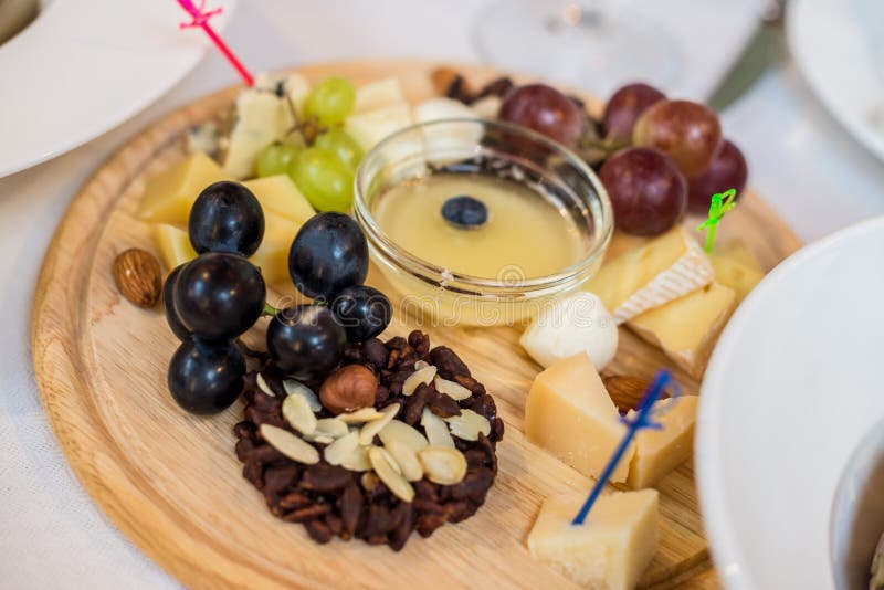 Cheese plate, grapes, nuts stock photo. Image of camembert 74757536