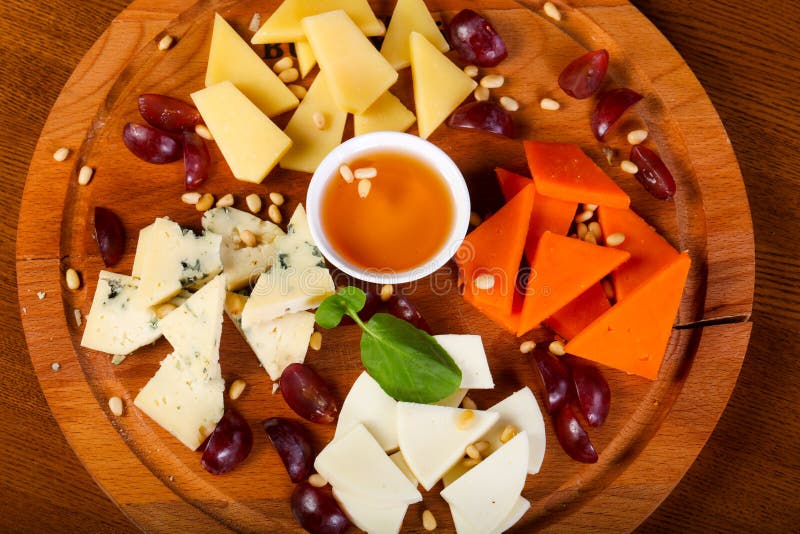 Cheese plate with honey stock image. Image of plate 127054103