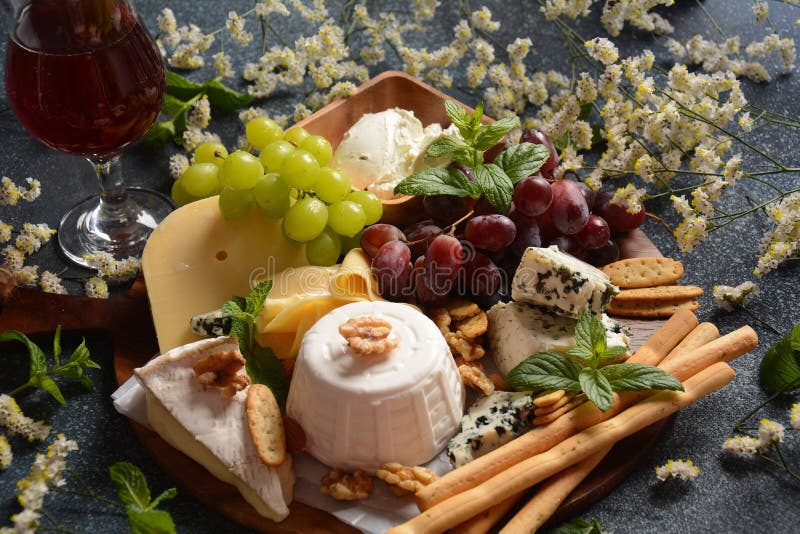 Cheese Platter with Assorted Cheeses, Grapes, Nuts and Snacks Stock