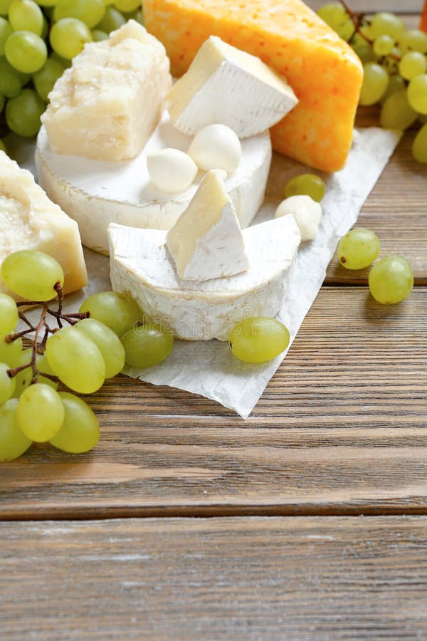 Cheese platter with grapes stock photo. Image of delicatessen 43602296